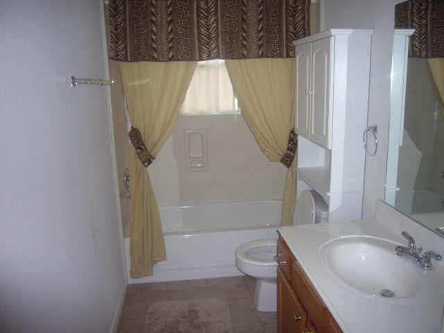 11514 Musetta Ct, Cypress, TX 77429 - bathroom with vanity and washtub / shower combination