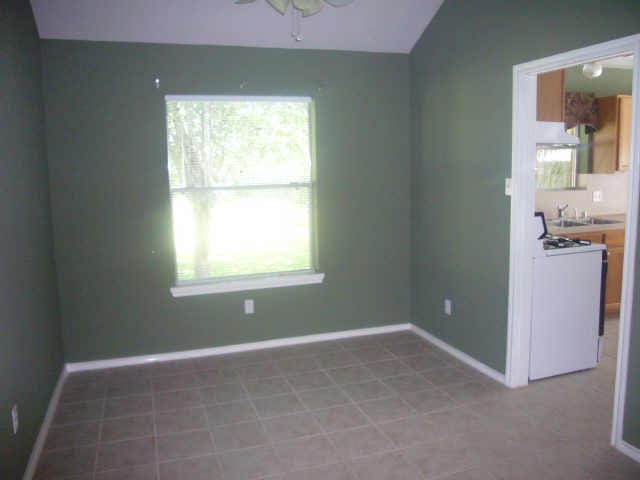 11514 Musetta Ct, Cypress, TX 77429 - unfurnished dining area with ceiling fan and vaulted ceiling