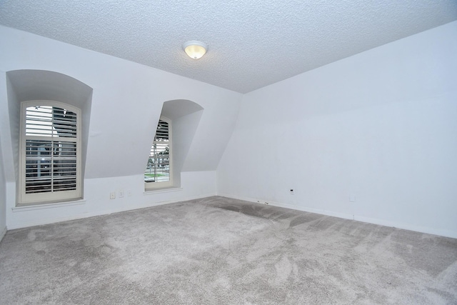 2635 Marilee Ln Unit 2635, Houston, TX 77057 - bonus room featuring carpet flooring, arched walkways, and a textured ceiling
