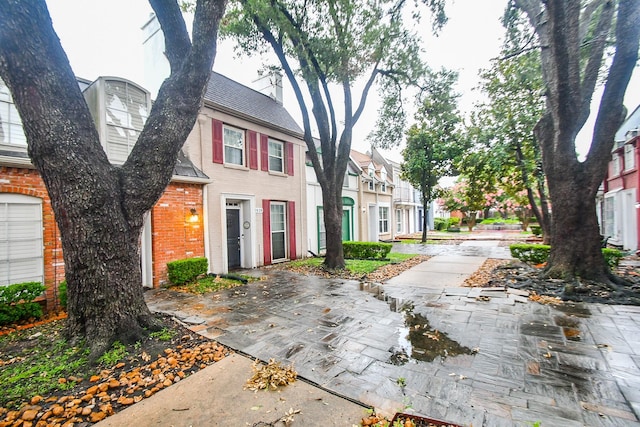2635 Marilee Ln Unit 2635, Houston, TX 77057 - view of front facade featuring brick siding and a shingled roof