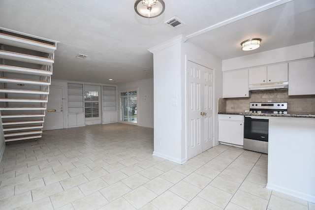 2635 Marilee Ln Unit 2635, Houston, TX 77057 - kitchen featuring under cabinet range hood, stainless steel stove, light tile patterned floors, decorative backsplash, and dark countertops