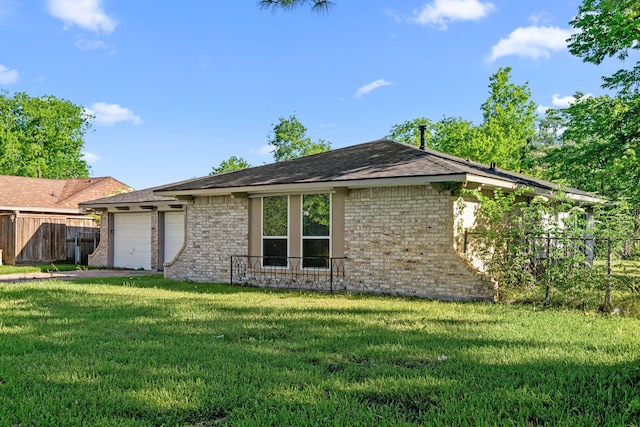 6611 Mohawk St, Houston, TX 77016 - view of side of home with brick siding, a garage, and a shingled roof