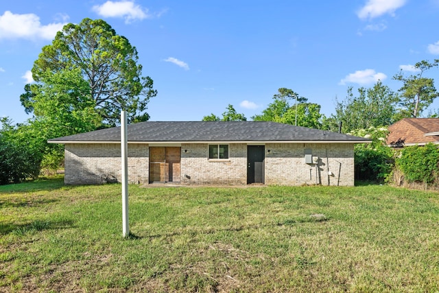 6611 Mohawk St, Houston, TX 77016 - rear view of property featuring a yard and brick siding