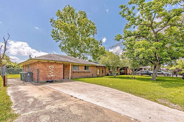 11058 Vailview Dr, Houston, TX 77016 - view of front of home with a gate, concrete driveway, and brick siding