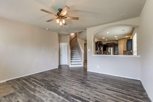 23606 Stargazer Pt, Spring, TX 77373 - unfurnished living room with dark wood-style floors, a ceiling fan, arched walkways, stairs, and recessed lighting