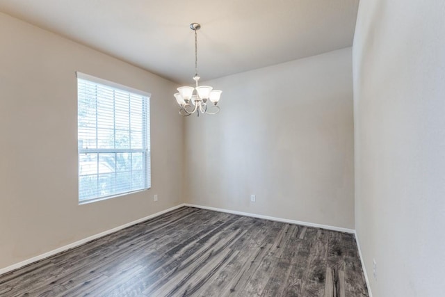 23606 Stargazer Pt, Spring, TX 77373 - spare room featuring dark wood-type flooring, healthy amount of natural light, and a chandelier