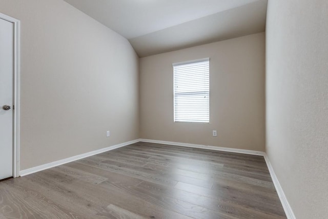 23606 Stargazer Pt, Spring, TX 77373 - empty room featuring wood finished floors and vaulted ceiling