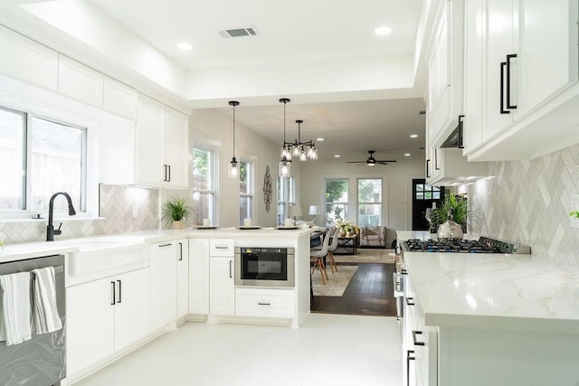 1020 E 16th St, Houston, TX 77009 - kitchen with appliances with stainless steel finishes, a ceiling fan, a peninsula, backsplash, and recessed lighting