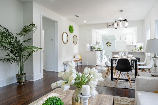 1020 E 16th St, Houston, TX 77009 - living room featuring dark wood finished floors, a chandelier, and recessed lighting