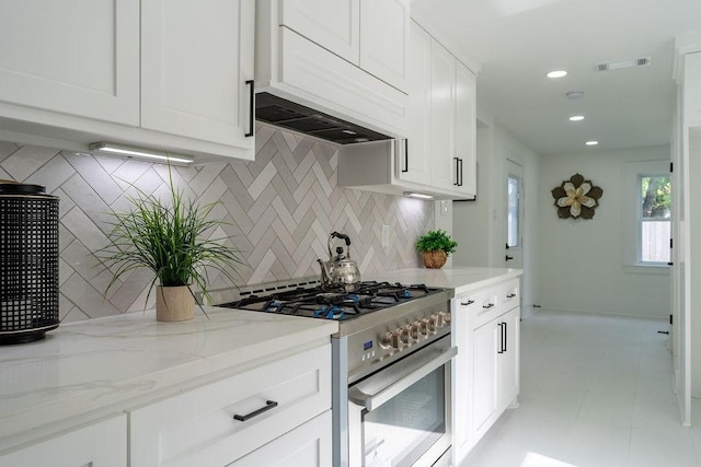 1020 E 16th St, Houston, TX 77009 - kitchen with high end stainless steel range oven, backsplash, white cabinetry, light stone counters, and recessed lighting