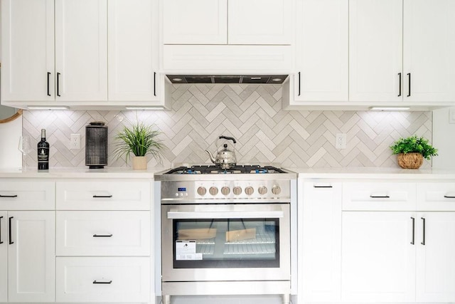 1020 E 16th St, Houston, TX 77009 - kitchen with high end range, light countertops, decorative backsplash, and white cabinetry