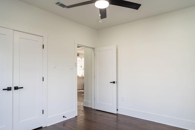 1020 E 16th St, Houston, TX 77009 - unfurnished bedroom with dark wood finished floors, a ceiling fan, and a closet