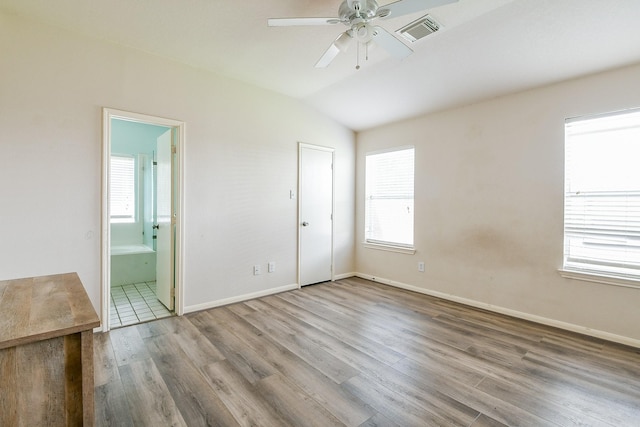 2526 Hidden Park Ln, Conroe, TX 77385 - empty room with a ceiling fan, wood finished floors, and vaulted ceiling