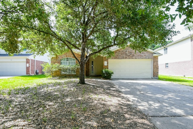 2526 Hidden Park Ln, Conroe, TX 77385 - view of front of house featuring a garage, concrete driveway, and brick siding