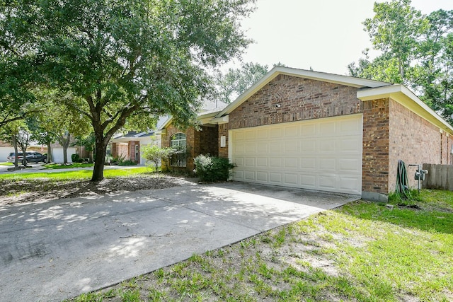 2526 Hidden Park Ln, Conroe, TX 77385 - ranch-style home featuring a garage, driveway, and brick siding