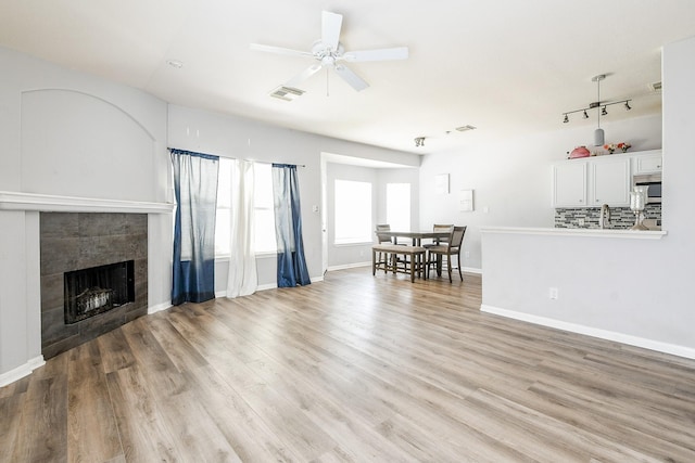 2526 Hidden Park Ln, Conroe, TX 77385 - living area featuring a fireplace, light wood-style floors, and a ceiling fan