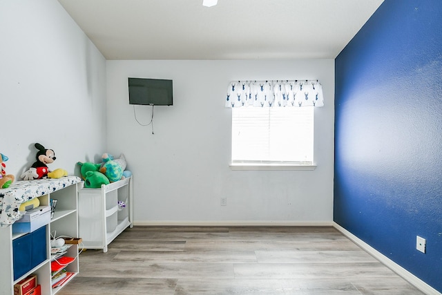 2526 Hidden Park Ln, Conroe, TX 77385 - rec room with wood finished floors and baseboards