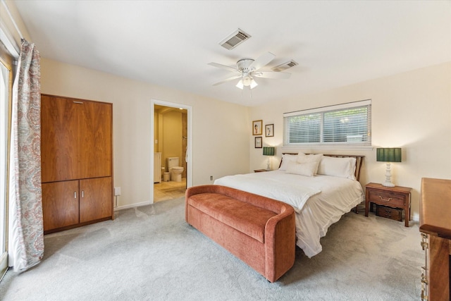 10050 Locke Ln, Houston, TX 77042 - bedroom with light colored carpet, ceiling fan, and connected bathroom