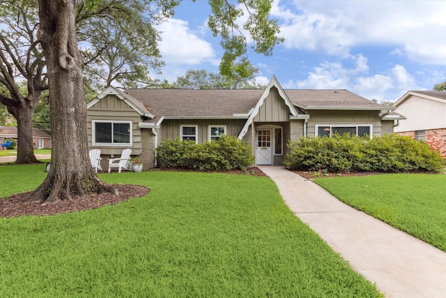 10050 Locke Ln, Houston, TX 77042 - view of front facade with a front yard, brick siding, and a shingled roof
