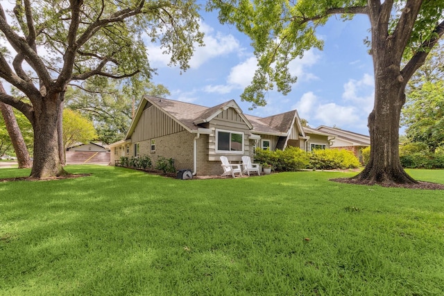 10050 Locke Ln, Houston, TX 77042 - view of side of home with brick siding, board and batten siding, a yard, and a garage