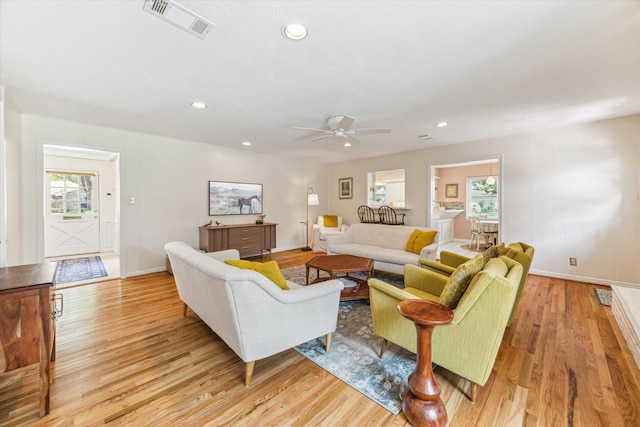 10050 Locke Ln, Houston, TX 77042 - living room with light wood finished floors, a ceiling fan, and recessed lighting