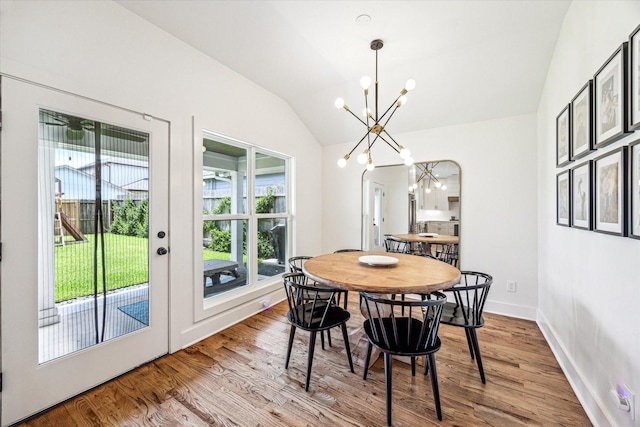 1247 Martin St, Houston, TX 77018 - dining area with a chandelier, vaulted ceiling, and wood finished floors