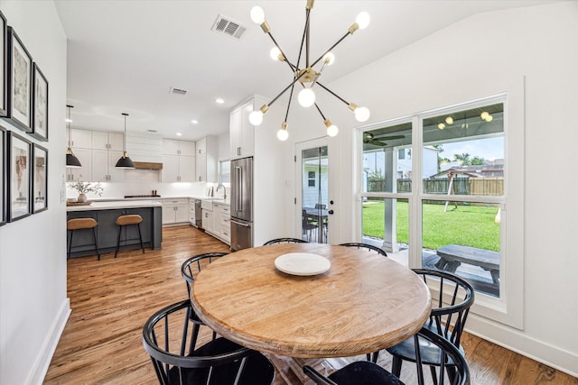 1247 Martin St, Houston, TX 77018 - dining area with a chandelier, light wood-style flooring, and recessed lighting