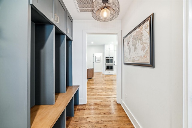 1247 Martin St, Houston, TX 77018 - mudroom featuring a chandelier and light wood finished floors