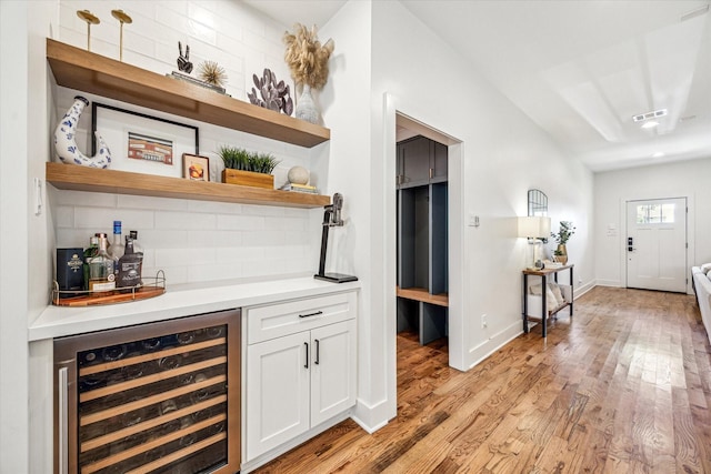 1247 Martin St, Houston, TX 77018 - indoor dry bar featuring beverage cooler, light wood finished floors, and backsplash