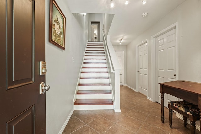 2911 Clay St, Houston, TX 77003 - stairway featuring tile patterned flooring and baseboards