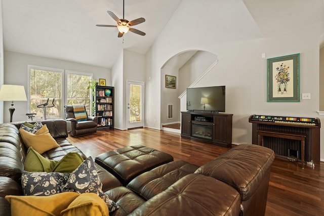 2911 Clay St, Houston, TX 77003 - living room with wood finished floors, a ceiling fan, high vaulted ceiling, arched walkways, and a fireplace