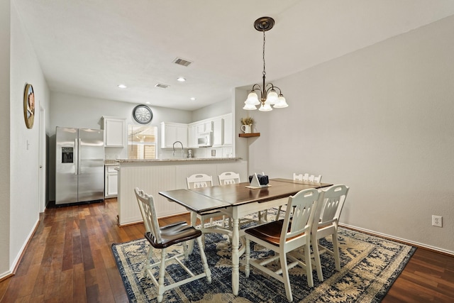 2911 Clay St, Houston, TX 77003 - dining space with dark wood-style flooring and a chandelier