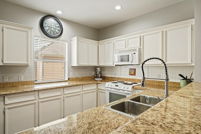 2911 Clay St, Houston, TX 77003 - kitchen featuring white appliances, recessed lighting, and white cabinetry