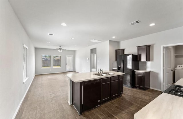 23322 Pelham Prairie Ln, Spring, TX 77373 - kitchen featuring black dishwasher, fridge with ice dispenser, dark wood-style flooring, light countertops, and washer / clothes dryer