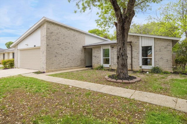 11331 Woollcott St, San Antonio, TX 78251 - mid-century modern home with a garage, brick siding, and driveway