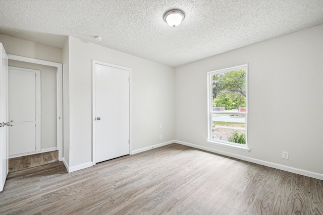 11331 Woollcott St, San Antonio, TX 78251 - unfurnished bedroom with wood finished floors and a textured ceiling