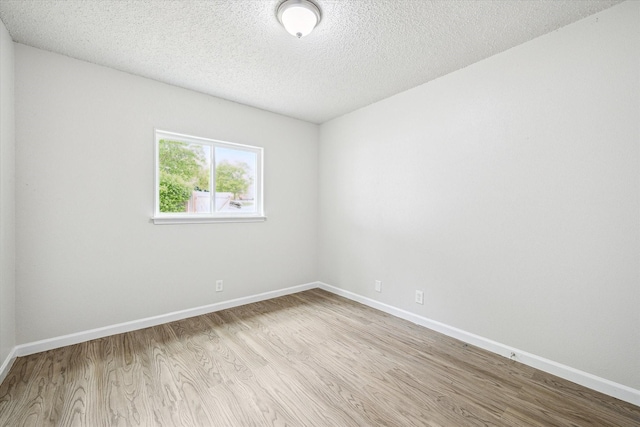 11331 Woollcott St, San Antonio, TX 78251 - empty room with wood finished floors and a textured ceiling
