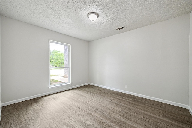 11331 Woollcott St, San Antonio, TX 78251 - unfurnished room featuring dark wood-style floors and a textured ceiling