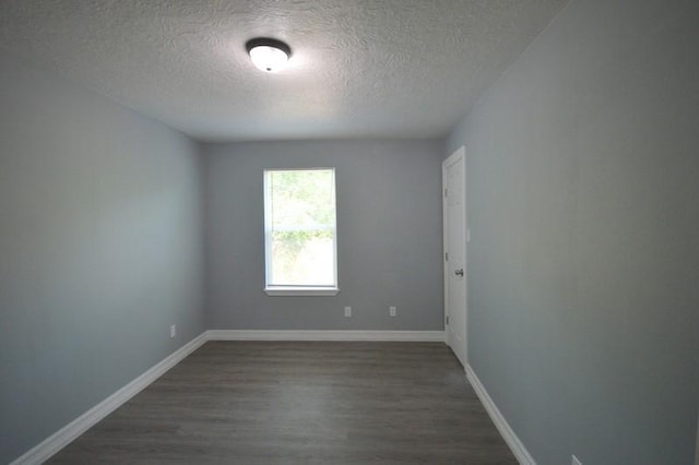 3007 Tuam St, Houston, TX 77004 - spare room with a textured ceiling and dark wood-style flooring