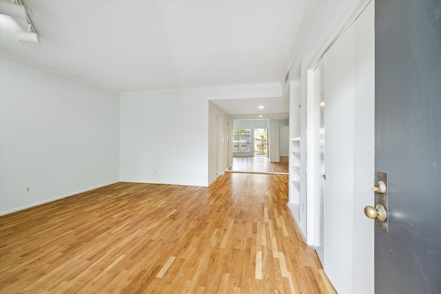 1100 Augusta Dr Unit 63, Houston, TX 77057 - unfurnished room with crown molding and light wood-style flooring