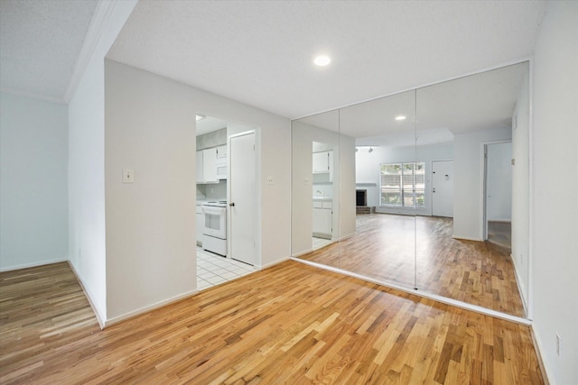 1100 Augusta Dr Unit 63, Houston, TX 77057 - unfurnished living room with light wood-type flooring and recessed lighting