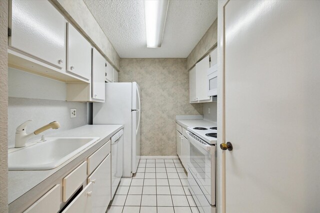 1100 Augusta Dr Unit 63, Houston, TX 77057 - kitchen featuring white appliances, light tile patterned flooring, white cabinetry, light countertops, and a textured ceiling