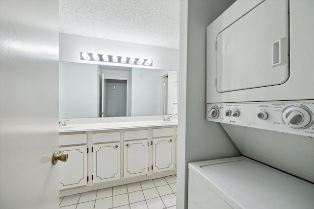 1100 Augusta Dr Unit 63, Houston, TX 77057 - laundry area with stacked washer / drying machine and light tile patterned floors