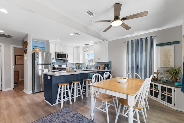 16711 Kingston Way, Galveston, TX 77554 - dining space with a ceiling fan, wood finished floors, and recessed lighting