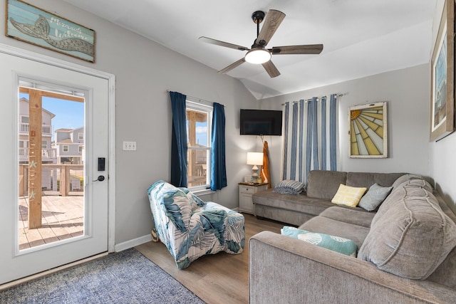 16711 Kingston Way, Galveston, TX 77554 - living room with healthy amount of natural light, ceiling fan, wood finished floors, and vaulted ceiling