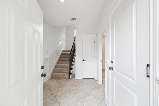 306 Felt Cir, Houston, TX 77011 - entryway with light marble finish flooring, stairway, and a decorative wall