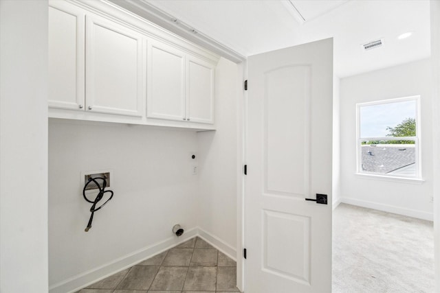 306 Felt Cir, Houston, TX 77011 - washroom featuring cabinet space, electric dryer hookup, hookup for a washing machine, and light tile patterned flooring