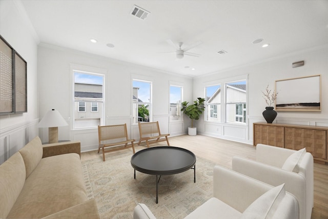 306 Felt Cir, Houston, TX 77011 - living area featuring crown molding, light wood-style floors, a decorative wall, a ceiling fan, and recessed lighting