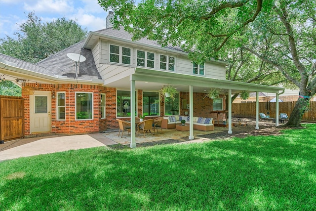 22811 Northampton Pines Dr, Spring, TX 77389 - back of property with outdoor lounge area, brick siding, a shingled roof, a patio area, and a chimney