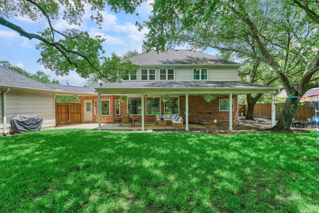 22811 Northampton Pines Dr, Spring, TX 77389 - rear view of house featuring a patio, an outdoor hangout area, brick siding, and a shingled roof